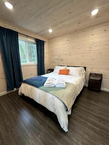 a bedroom with a large bed in a wooden room at Gorgeous Cabin Settled in the Middle of the Mountain in Anchorage, Alaska in Chugiak