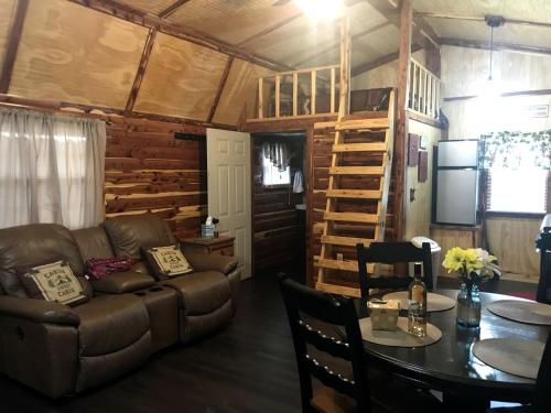 a living room with a couch and a table at Cozy Cabin Rental on Vineyard in Allen, Oklahoma in Allen
