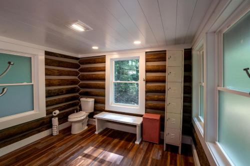 a bathroom with a toilet and a window at Remote Vintage Camper Rental for Adult-Only Retreat in Franklin, North Carolina in Franklin