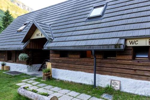 a house with a sign that says wc on it at Inviting Room Rental for a Vacation in the Stunning Setting of Soca, Slovenia in Soča