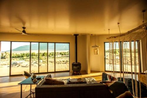 a living room with a couch and large windows at Stunning Lone Pine Accommodation for Romantic Getaways in California in Lone Pine