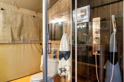 a bathroom with a toilet and a shower at Incredible Tented Cabin with Fire Pit and Hot-tub in Sevierville, Tennessee in Wear Valley