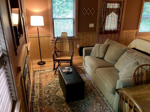 a living room with a couch and a chair at Luxury Cabin Rental with Beautiful Water Views near Charlotte, North Carolina in Elkin