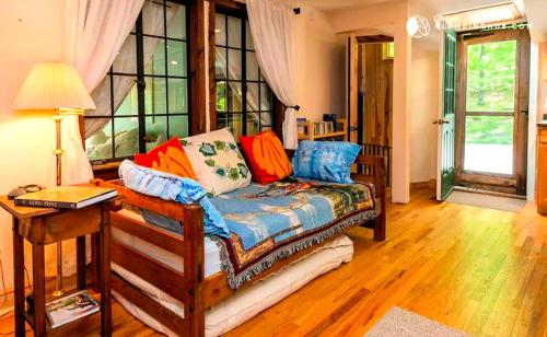 a living room with a couch and a table at Peaceful Getaway above a Beautiful Yoga Studio near Devil's Den Nature Preserve, Connecticut in Redding