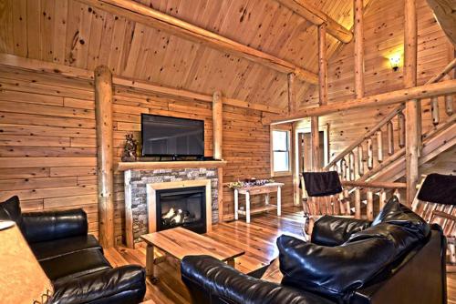 a living room with leather furniture and a fireplace at Rustic Fishing Lodge Rental with a Spacious Deck in Logan, Ohio in Cedar Grove