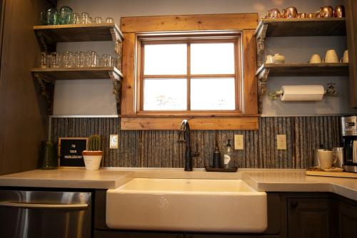 a kitchen with a sink and a window at Charming Historic-Inspired Vacation Home with Mountain Views near Pony School House in Pony, Montana in Pony