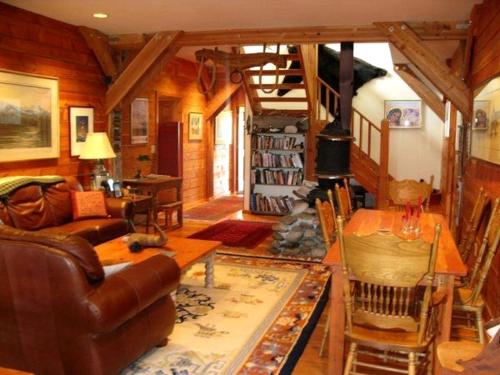 a living room with a couch and a table at Remote Six-Bedroom Lodge for Rent near the Chico Hot Springs, Montana in Flying Y Ranch Airport