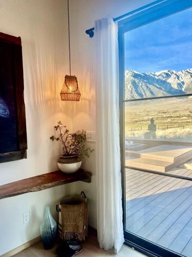 a door to a balcony with a view of a mountain at Luxury Design Rental with Breathtaking Mountain Views in Lone Pine, California in Lone Pine