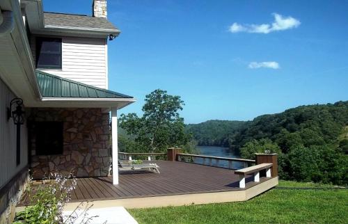 a deck with a bench on the side of a house at King Suite for a Cozy Romantic Getaway Overlooking the New River in Independence, Virginia in Independence