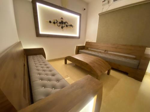 a room with a bench and a table and a picture at La Tamara Luxury - TIE Hotels & Resorts in Pondicherry