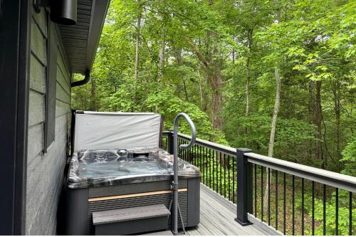 a chair on the porch of a house at Hot-tub and Fire Pit Provided Cabin in Carbondale, Illinois in Makanda
