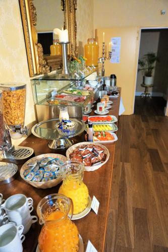 a buffet with many plates of food on a table at Hotel Holsteinische Schweiz am Dieksee in Malente