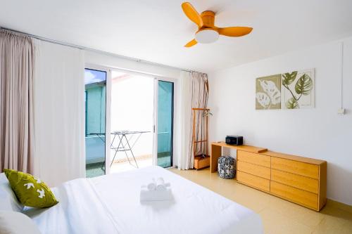 a bedroom with a bed and a ceiling fan at Grand Baie Family Residence in Grand Baie