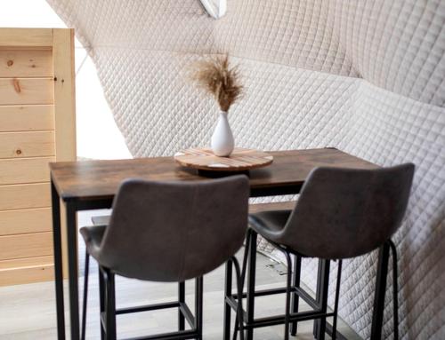 a dining room table with two chairs and a vase on it at Cozy Dome for a Romantic Weekend in Tennessee in Jones Cove
