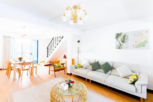 a living room with a white couch and a table at Grand Baie Family Residence in Grand Baie