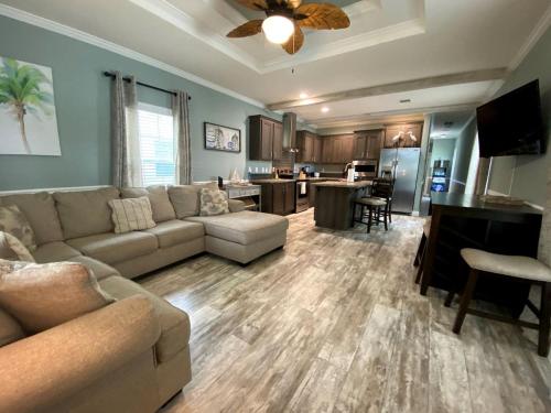 a large living room with a couch and a kitchen at Charming Cottage Surrounded by Trees in Dunnellon, Florida in Dunnellon