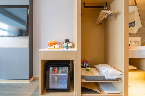a kitchen with a small refrigerator in a room at Atour Hotel Wuxi Huishan Wanda Plaza in Wuxi