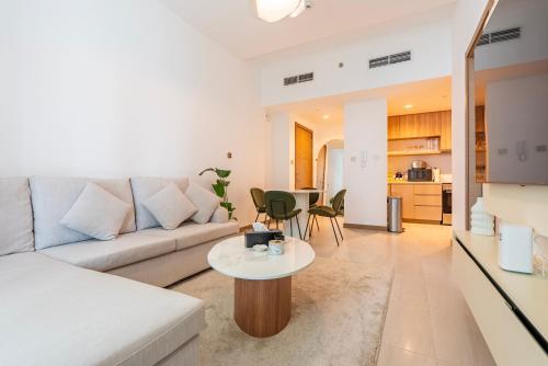 a living room with a couch and a table at Luxury 1 & 2 BHK Apartments, Branded & State of The Art Amenities in Dubai