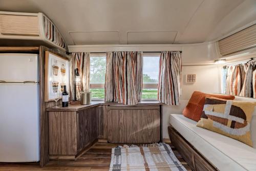 a living room with a couch and a window at Newly Renovated Camper with Fresh Decor and Tiny Deck in Texas in Spicewood