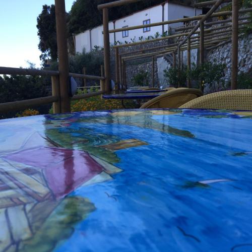 a painting of a swimming pool in the water at Fico D'India Relais in Furore
