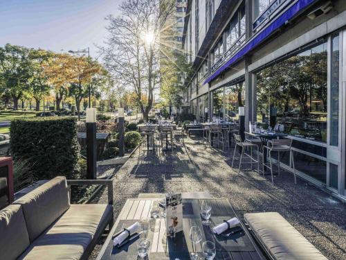 a restaurant with tables and chairs outside of a building at Mercure Mulhouse Centre in Mulhouse