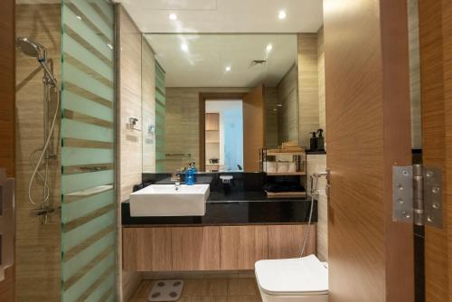 a bathroom with a sink and a toilet at Luxury 1 & 2 BHK Apartments, Branded & State of The Art Amenities in Dubai