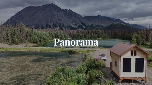 an aerial view of a small house next to a lake at Eco-Friendly Lakefront Tiny House with Views of Panorama Mountain near Denali National Park in Cantwell