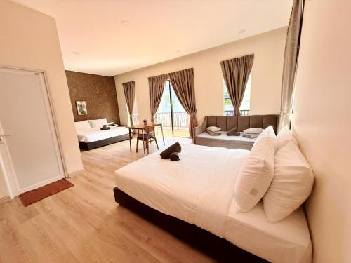 a bedroom with a bed and a living room at Sim Vintage Villa Langkawi in Kuah
