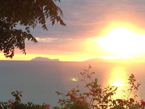 a sunset over a body of water with the sun setting at Villa Malandrino Guest House in Agropoli
