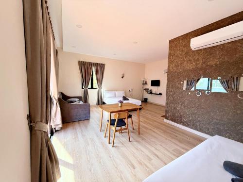a room with a table and a bed and a bedroom at Sim Vintage Villa Langkawi in Kuah