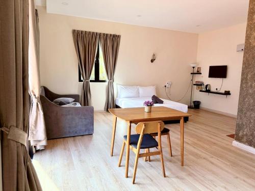 a room with a bed and a table and a bed and a bedroom at Sim Vintage Villa Langkawi in Kuah