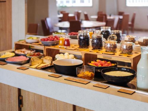 a buffet line with many different types of food at Mercure Rennes Centre Gare in Rennes