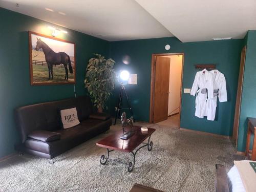a living room with a couch and a horse on the wall at Spacious Bed and Breakfast Suite on Horse Farm for Unique Getaway in Oak Harbor, Washington in Maple Grove Beach