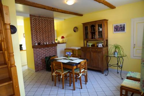a kitchen with a table and chairs in a room at Gîte Margot in Vacqueriette