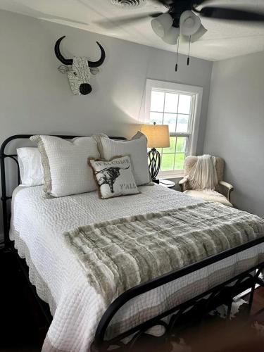 a bedroom with a bed and a ceiling fan at Spectacular Secluded Cottage in Round Top, Texas in Ledbetter