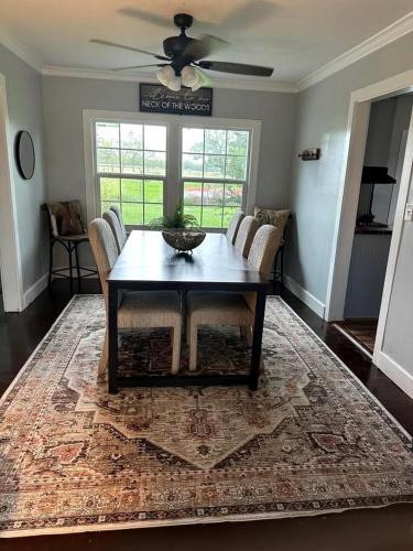 a dining room with a table and chairs on a rug at Spectacular Secluded Cottage in Round Top, Texas in Ledbetter