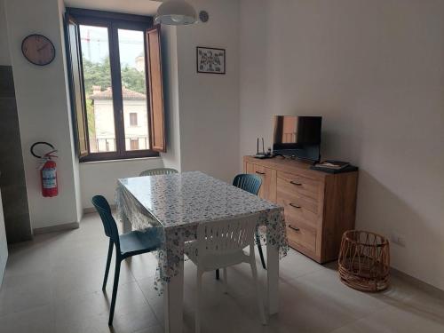a dining room with a table and chairs and a window at A window on San Bernardino in LʼAquila