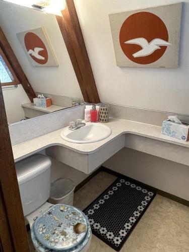 a bathroom with a sink and a toilet at Gorgeous A-Frame by the Beach in Otter Rock, Oregon in Otter Rock
