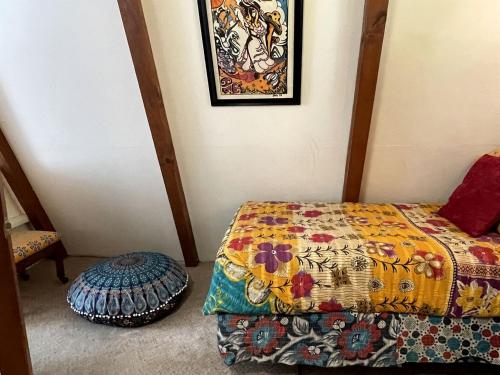 a bedroom with a bed with a colorful blanket at Gorgeous A-Frame by the Beach in Otter Rock, Oregon in Otter Rock
