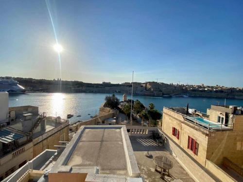 a view of a body of water with a cruise ship at Stay by the Grand Harbour of Valletta in Senglea