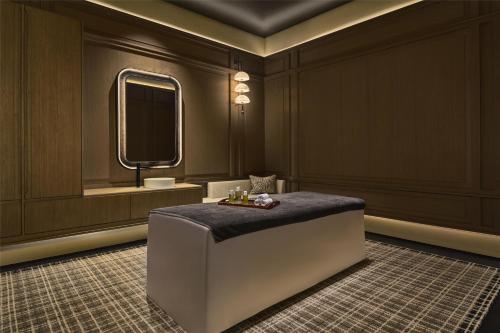 a bathroom with a vanity and a mirror at Shu Hua Hotel Tianmu Mountain, Curio Collection By Hilton in Hangzhou