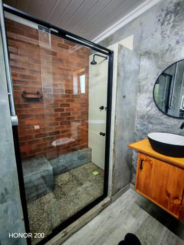 a bathroom with a shower and a sink at Oppi Plaas See Uitsig Seemeeu in Great Brak River