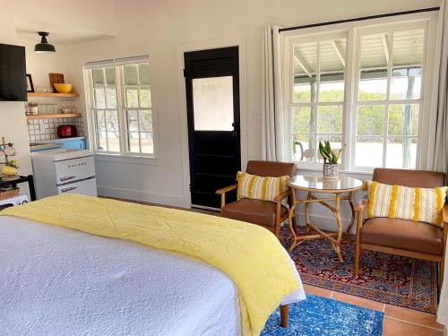 a bedroom with a bed and a table and chairs at Efficiency-Style Cabin with Spa Lovely for a Couples Escape in Hunt, Texas in Hunt