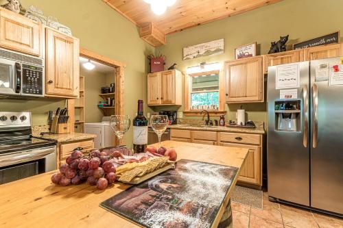 a kitchen with a wooden table with grapes on it at Relaxing Cabin with Screened Porch in Sautee Nacoochee, Georgia in Sautee Nacoochee