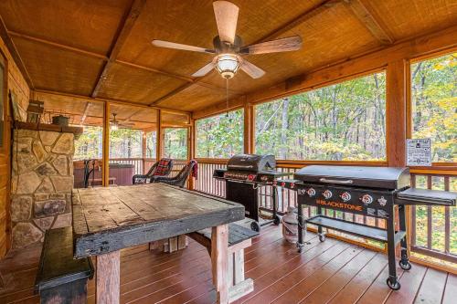 a dining room with a table and a ceiling fan at Relaxing Cabin with Screened Porch in Sautee Nacoochee, Georgia in Sautee Nacoochee