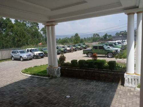 a group of cars parked in a parking lot at Hotel ikoro in Nyakabande