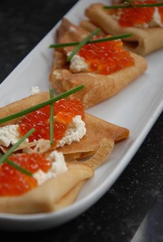 a white plate with three different types of food on it at Weena House in Rotterdam