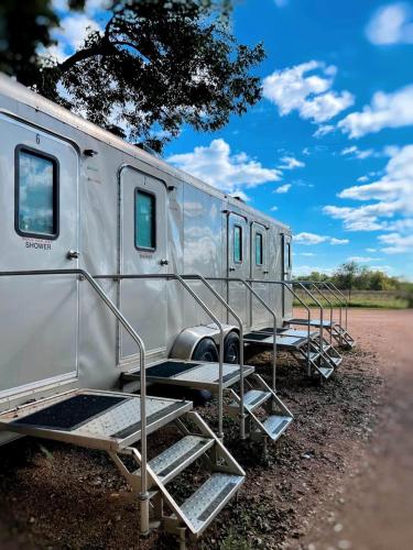 a silver trailer parked on the side of a road at 24 Son's Secluded Safari Tent in Kingsbury, TX in Staples