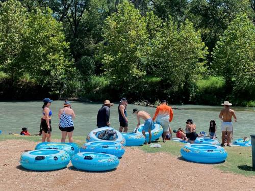 a group of people on a beach with blue frisbees at 24 Son's Secluded Safari Tent in Kingsbury, TX in Staples
