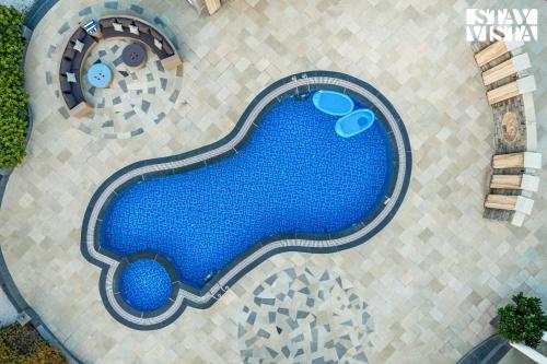 an overhead view of a swimming pool in a resort at StayVista at Vacanza Villa - Pool, Lawn & Theatre in Jaipur